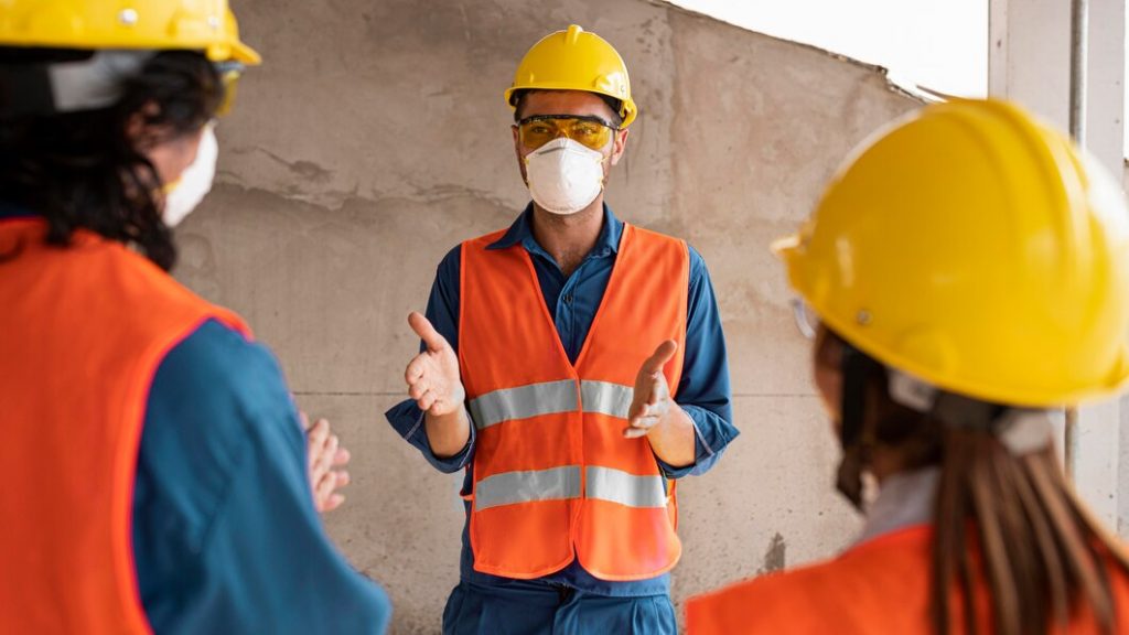 Contractor discussing with workers