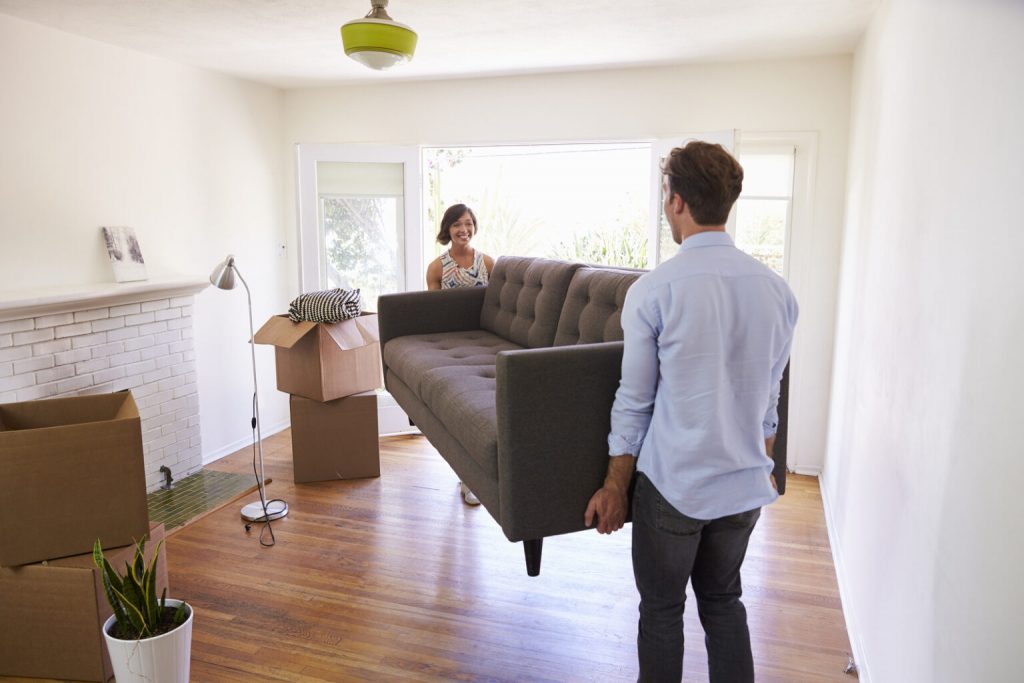 men and women adjusting furniture