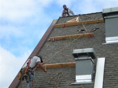 Workers working on house roof