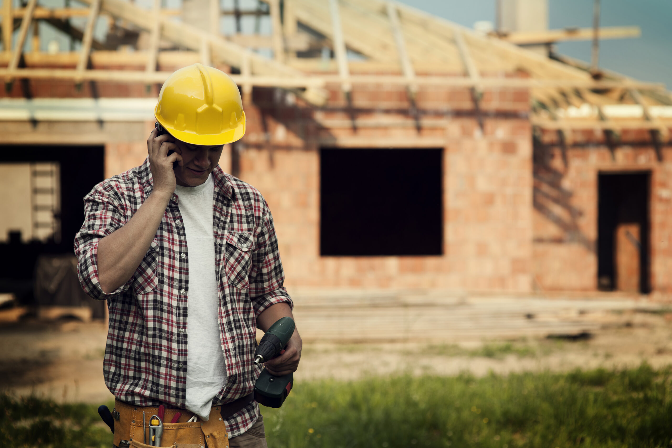 Worker talking on a phone on construction site