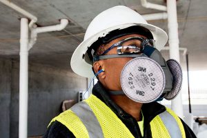 Worker wearing rust safety mask