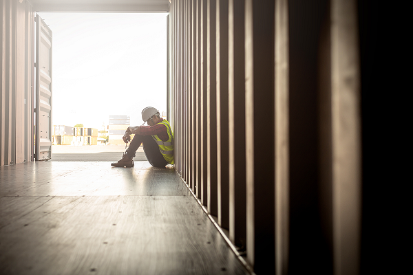 Worker sitting alone on construction site