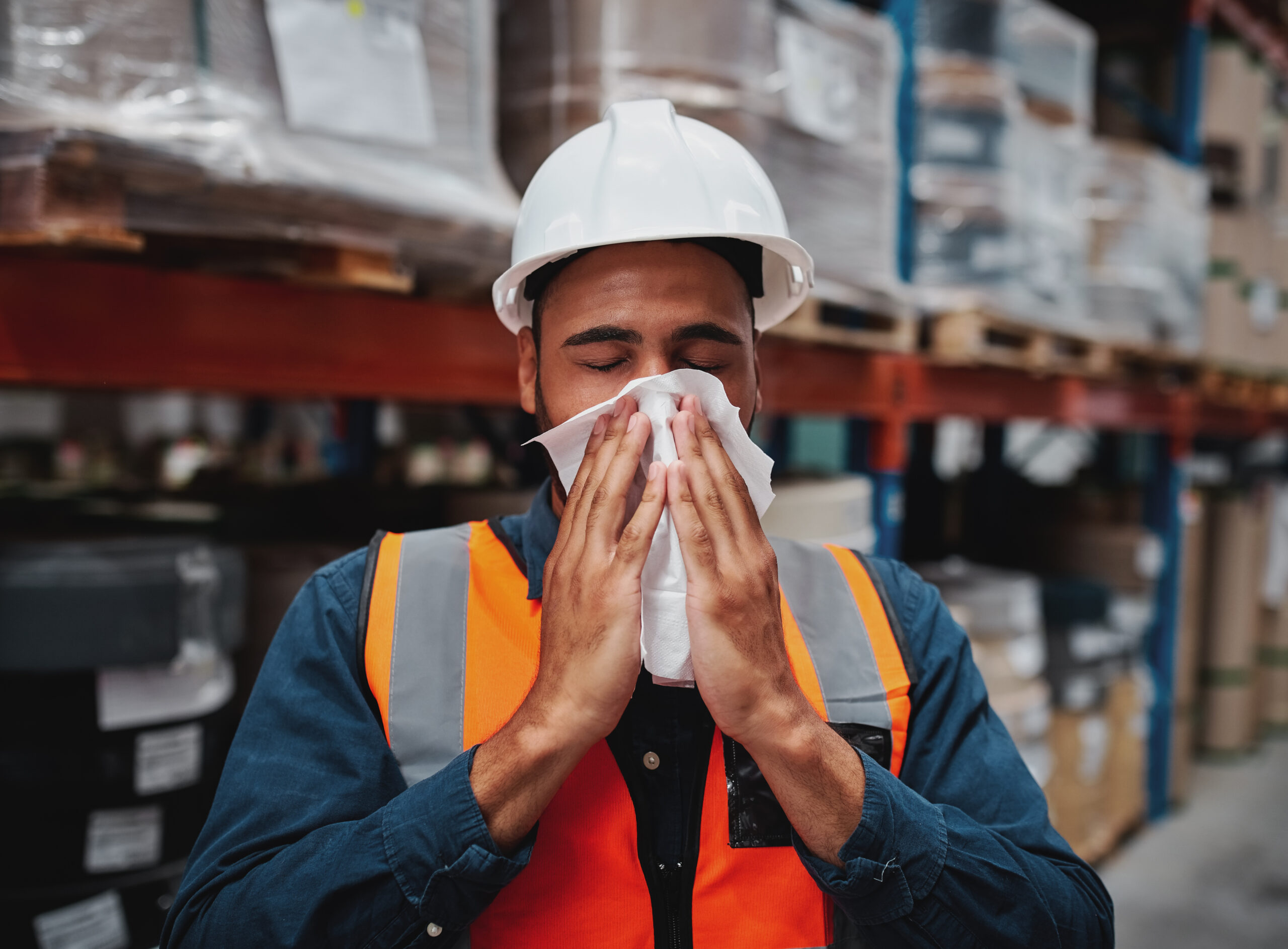 Worker sneezing in factory