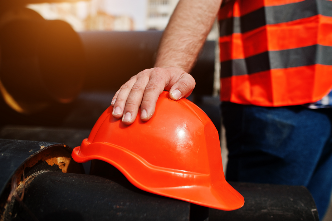 Safety helmet in worker hand